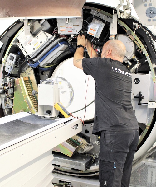 Open refurbished CT scanner with technician testing. LBN Medical.